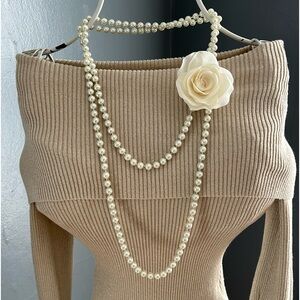 Long pearl strand necklace